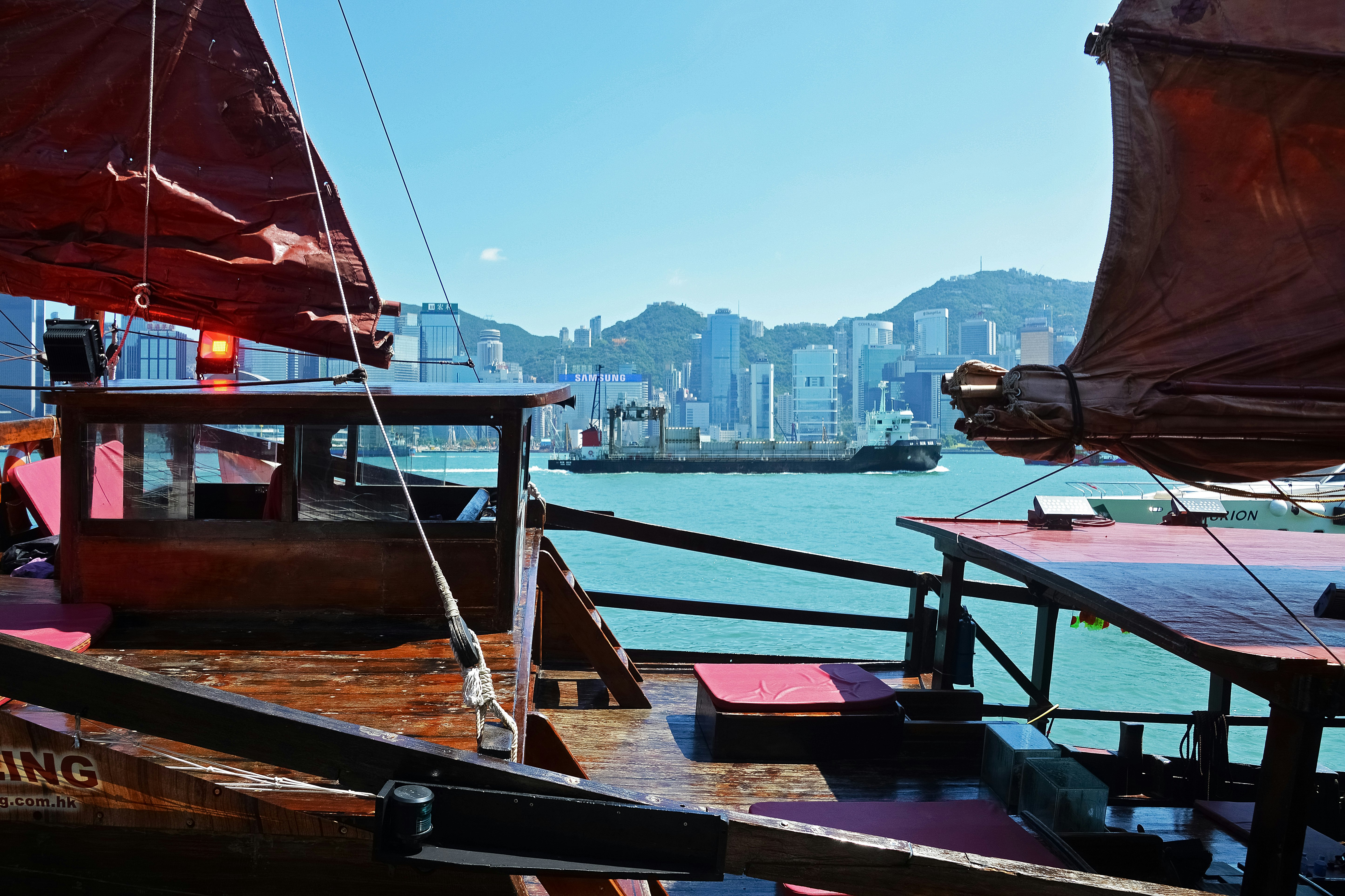 red and white sail boat on sea during daytime